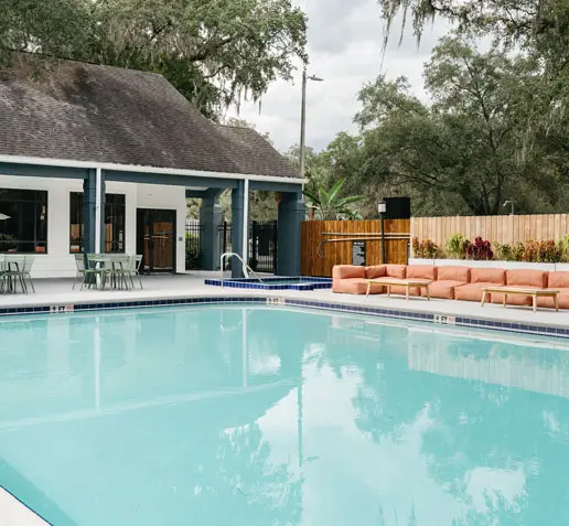 Pool with poolside seating at an apartment complex